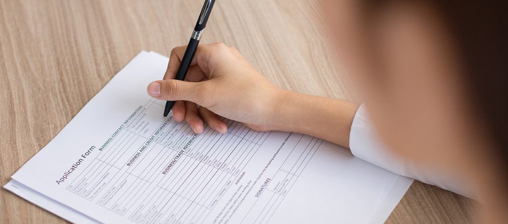 Closeup of Female Applicant Completing Form