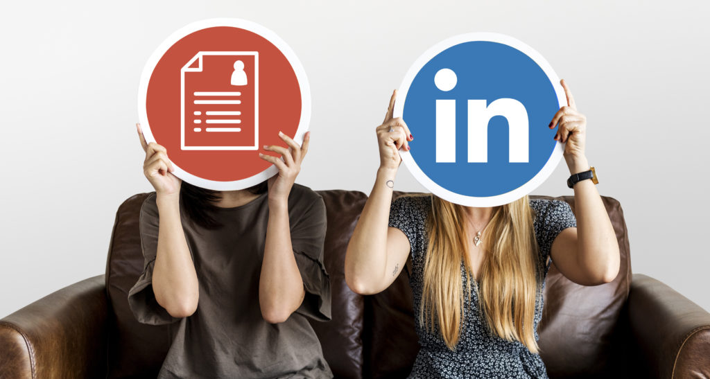 Interracial women holding icons representing Resumes VS LinkedIN