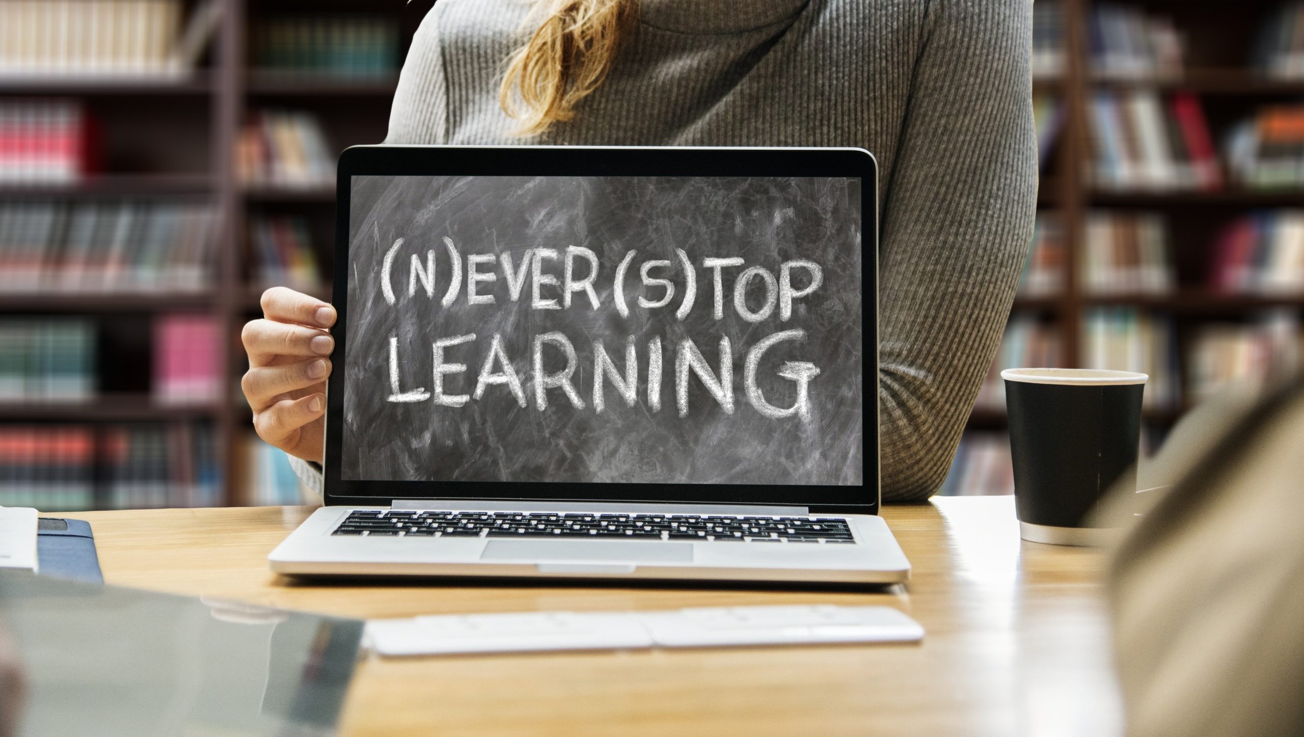 Image of laptop displaying the words "Never Stop Learning"